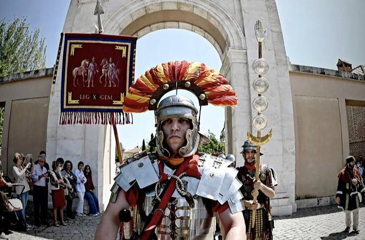 Miembros de la Asociación de Recreación Histórica Ab Urbe Condita, desfilan portando el vexilum de su unidad durante las actividades de las jornadas de recreación romana Complutum Renacida